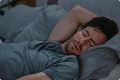 Man sweating in bed