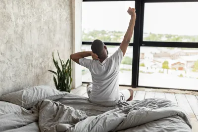 Man waking up naturally in bed