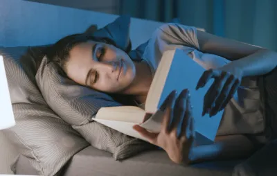 Women reading in bed before sleeping